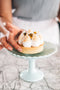 Italian passionfruit meringue tart made with passionfruit curd filling and topped with passionfruit pulp made fresh by tartlet bakery