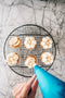chantilly cream piped on top of banoffee tart by tartlet bakery