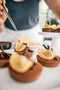 choc-orange tart made from chocolate shortcrust pastry base, orange crunch filling topped with a glossy dark chocolate ganache, garnished with dark chocolate shavings, dust of cocoa powder and a slice of candied orange made fresh by tartlet bakery