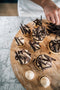 dark chocolate shavings topped onto espresso whipped cream filled tarts made fresh by tartlet bakery