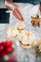 roasted coconut sprinkled onto raspberry tart with chantilly cream made fresh by tartlet bakery