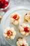 fresh raspberry on top of coconut and raspberry tart made from sweet shortcrust pastry, raspberry marshmallow filling, raspberry jelly, chantilly cream, sprinkled with roasted coconut and edible gold leaf