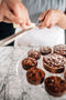 shaving white chocolate over nutella ganache tarts made fresh by tartlet bakery