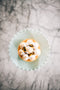 Italian passionfruit meringue tart made with passionfruit curd filling and topped with passionfruit pulp made fresh by tartlet bakery